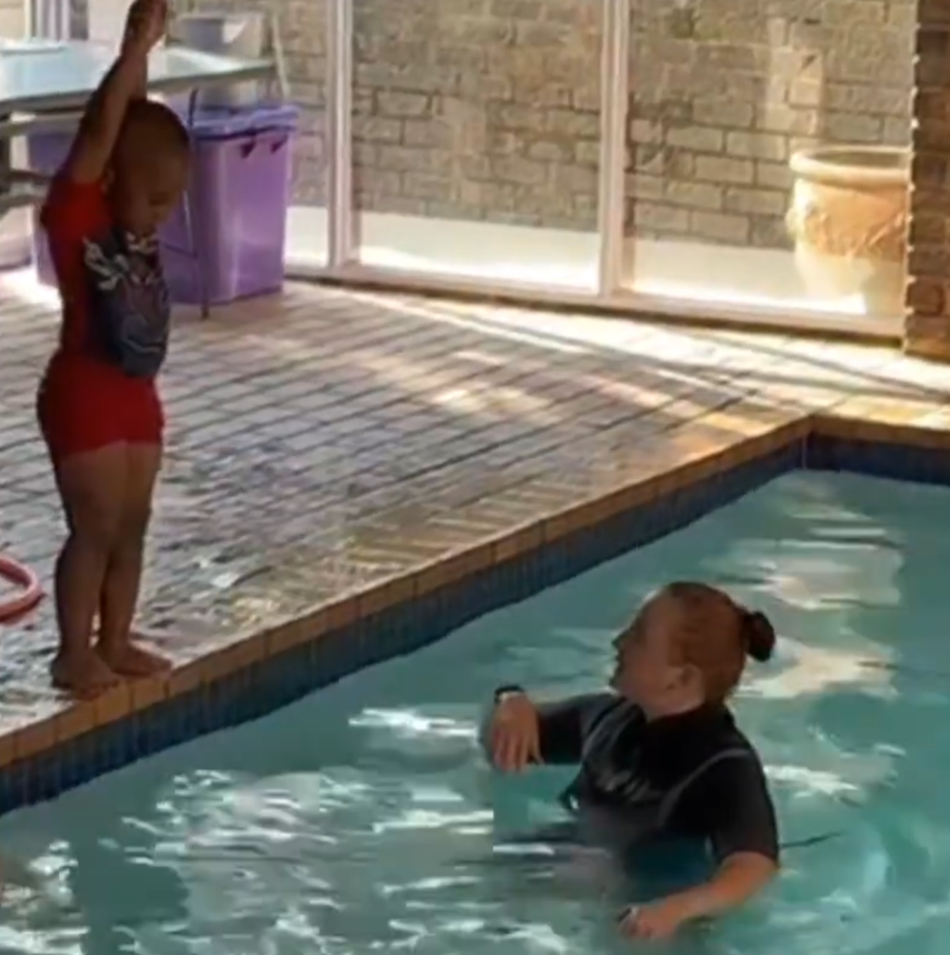 boy learning how to dive with instructor at splashmates swim school